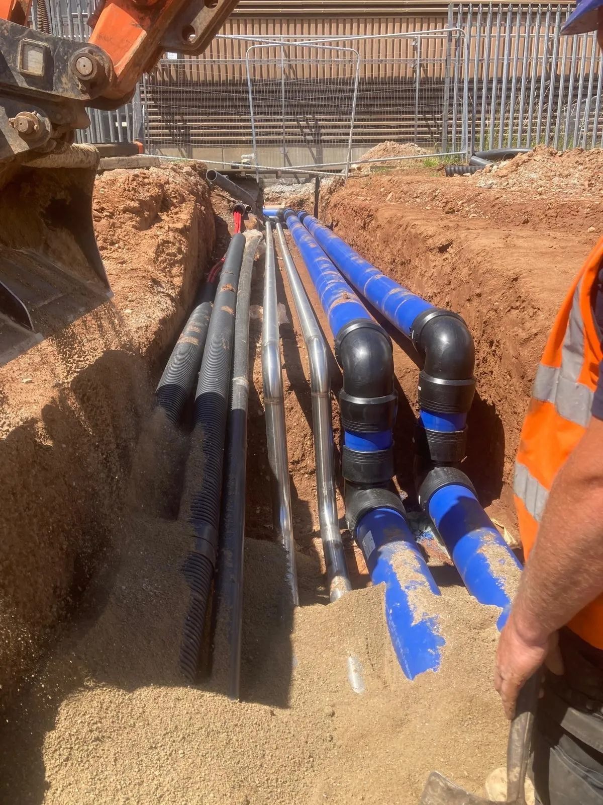 Blue water pipes and fittings laid in a trench