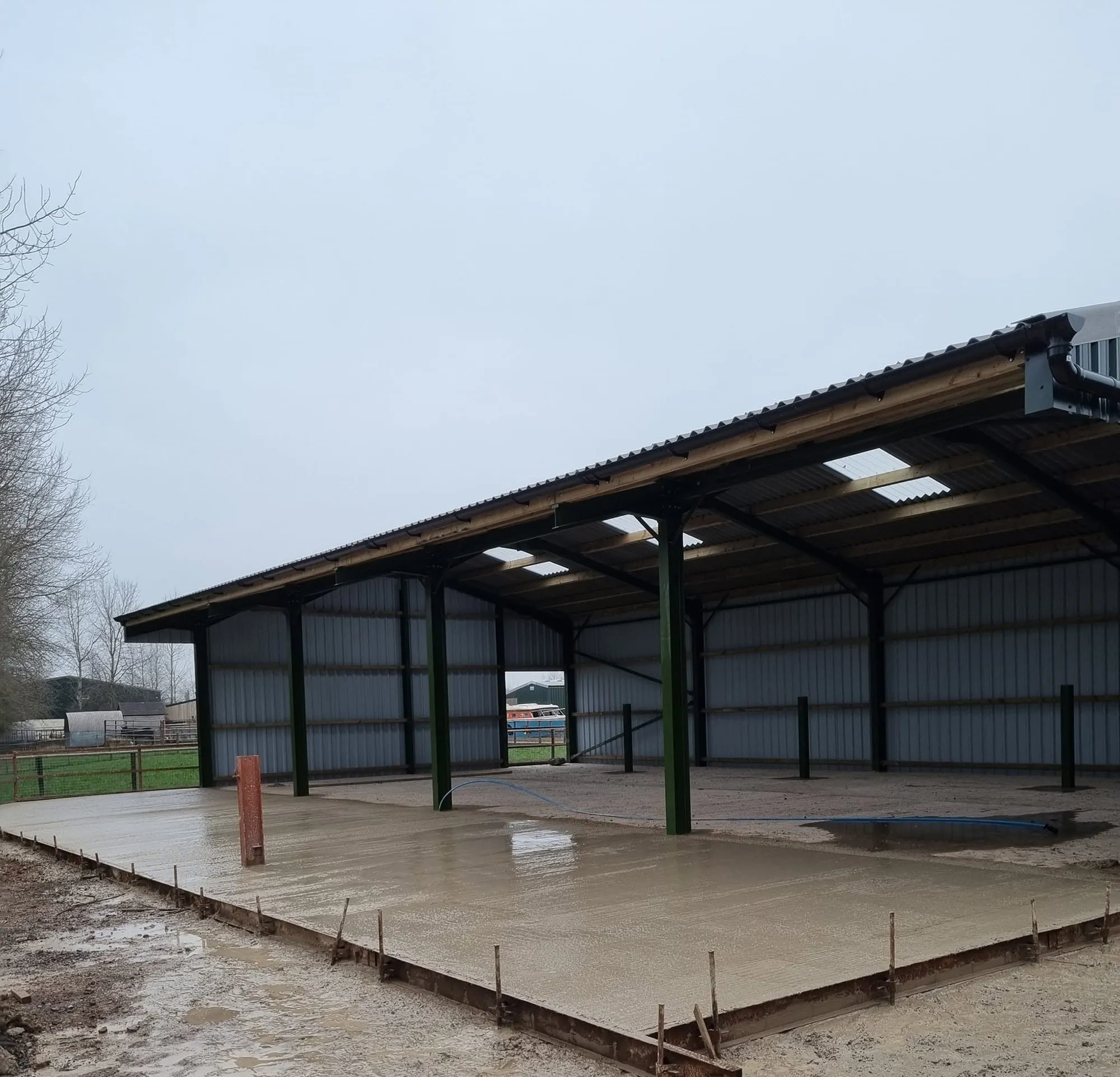 New concrete apron laid in front of an open-fronted farm building