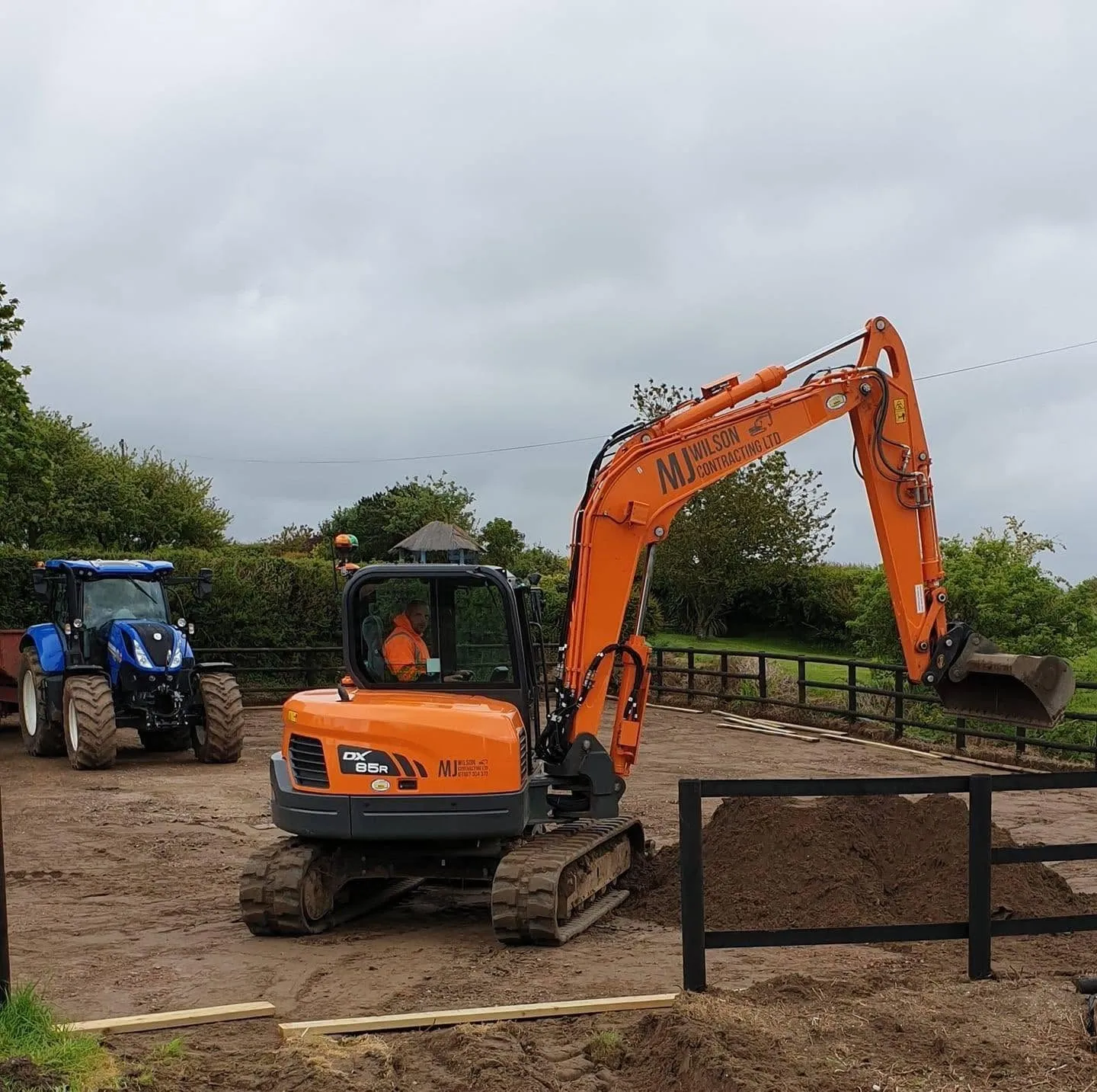 M J Wilson excavator with a tractor behind it on a site