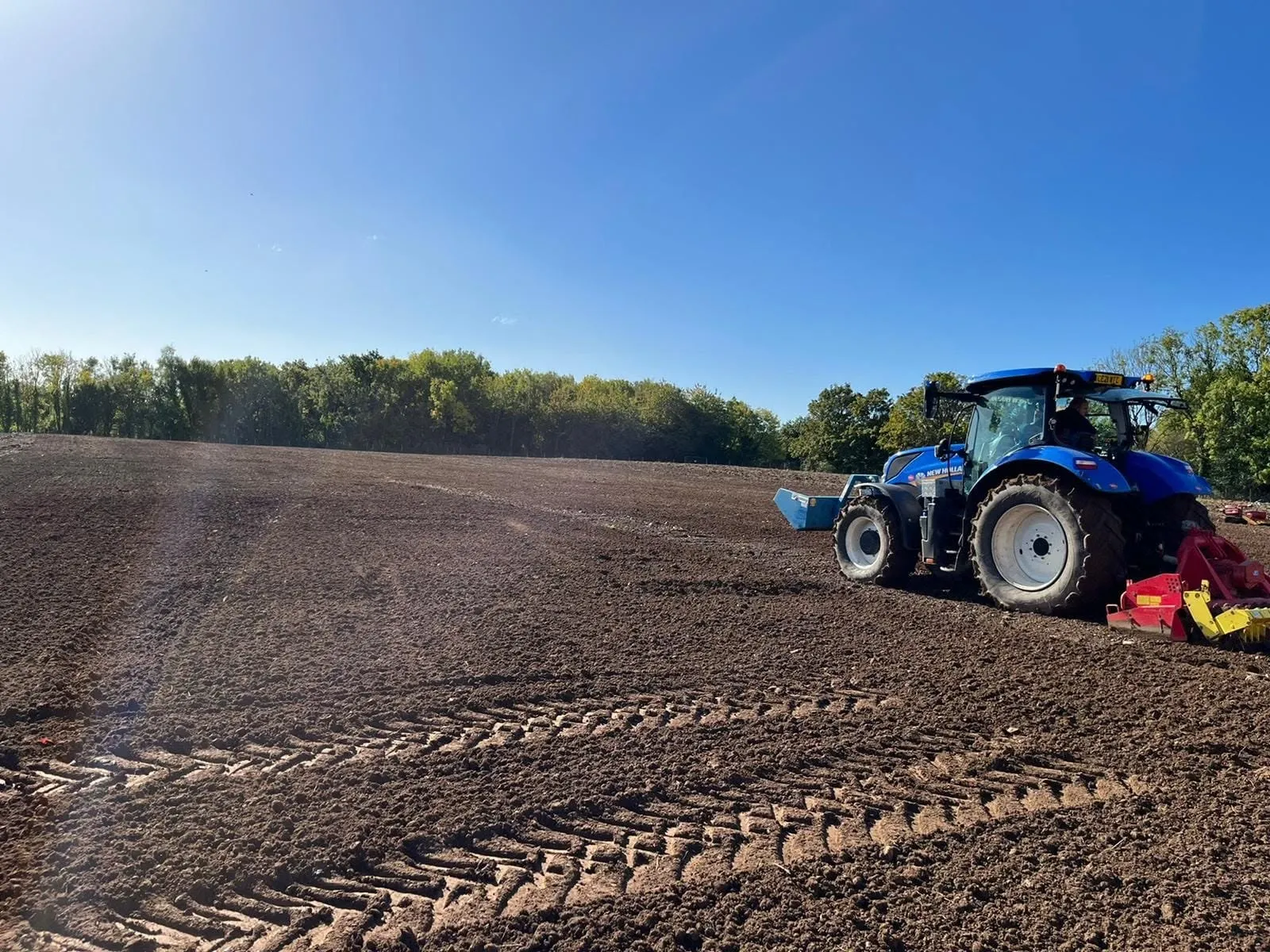 Tractor power harrowing a large field