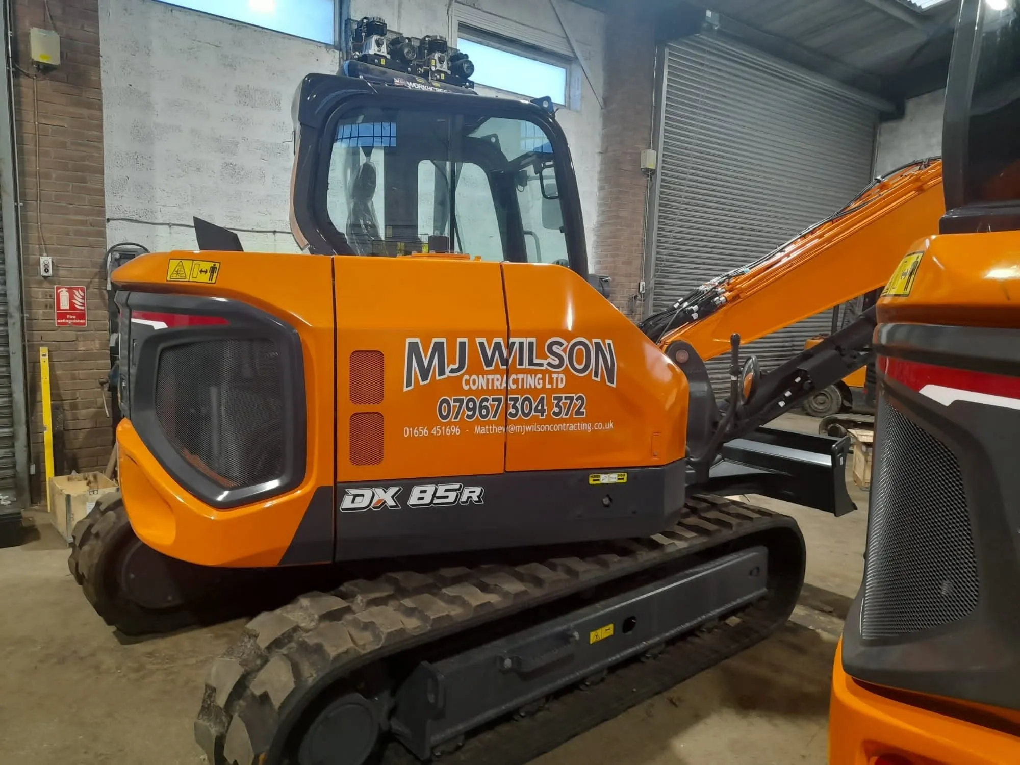 DX85R excavator in M J Wilson Contracting livery