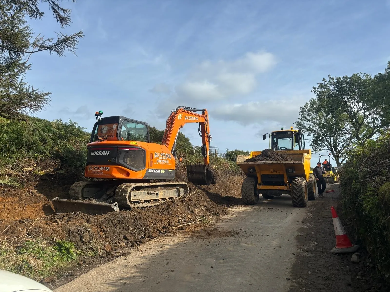 DX85R excavator and a dumper widening a lane
