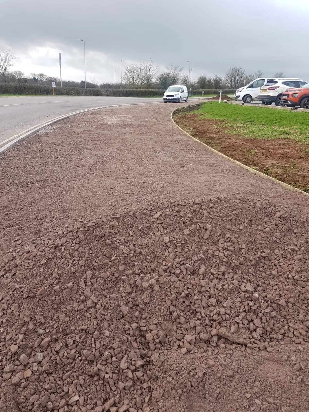 Finished kerb line with stone laid behind it on a bend