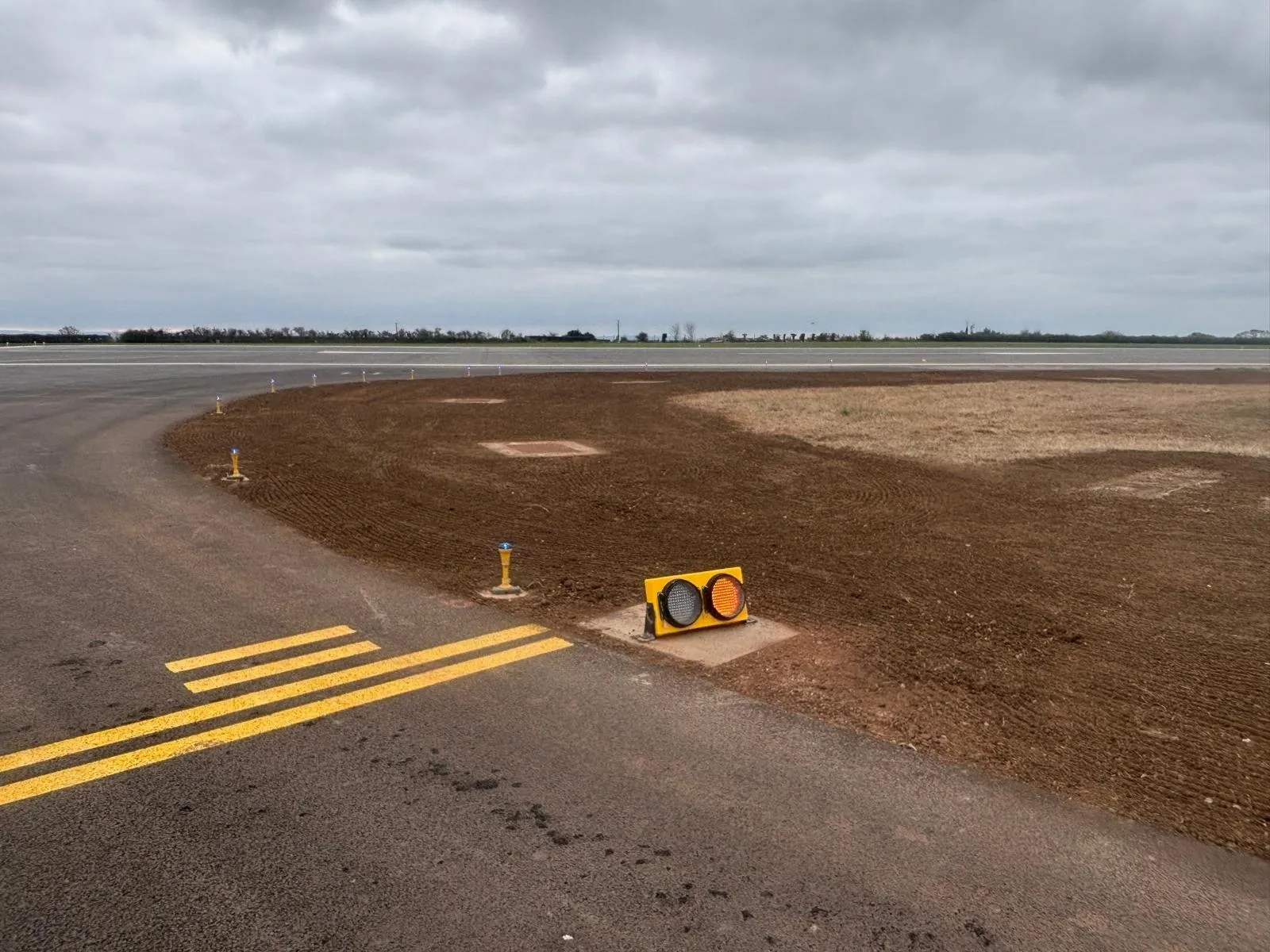 Reinstated ground around a taxiway junction with airfield lights in place