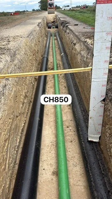 Water pipe and ducts laid in a sand-bedded trench with chainage marked