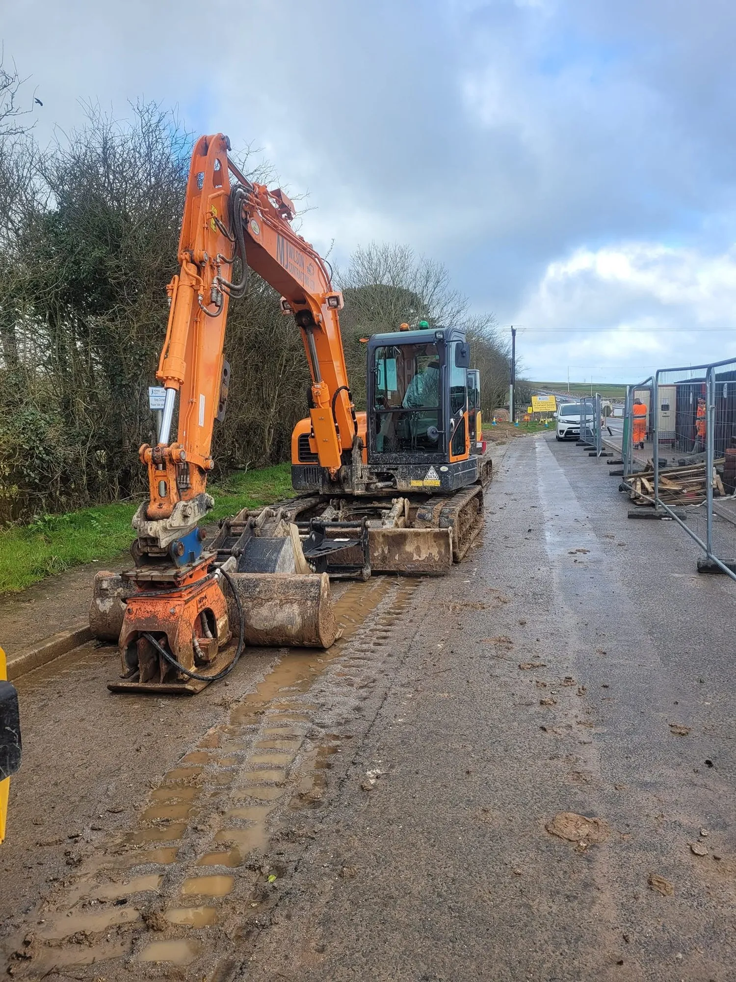 Two excavators parked on a site access road
