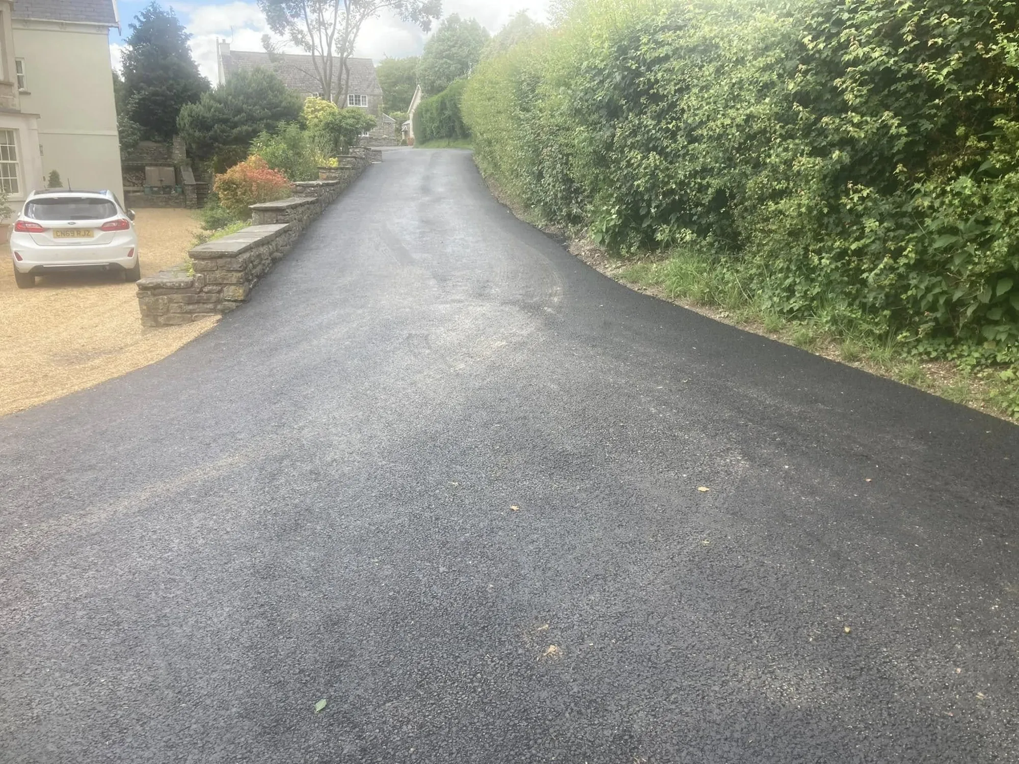 Freshly laid tarmac on a driveway approach