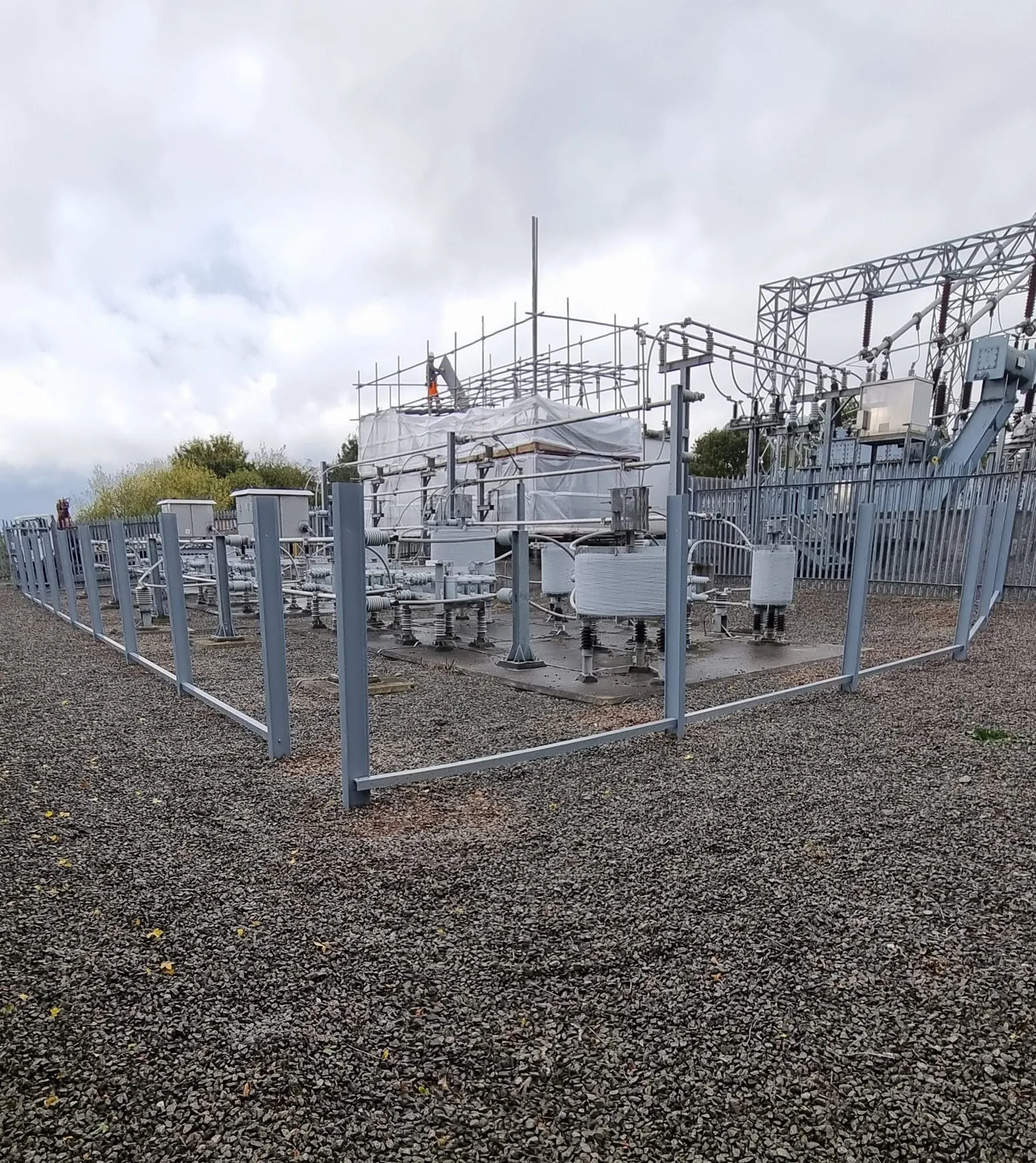 Fence posts and rails set out around the substation before the pales were fitted