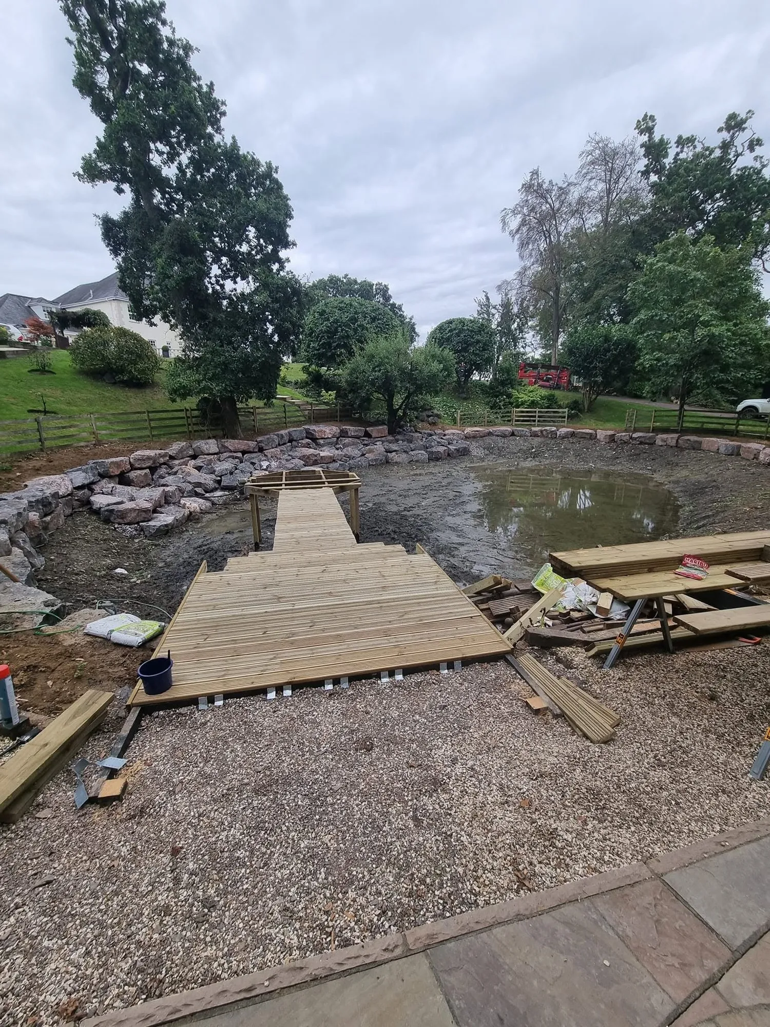 New timber decking platform at the edge of the restored pond