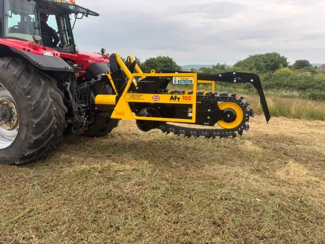 Tractor-mounted AFT 100 chain trencher in a field