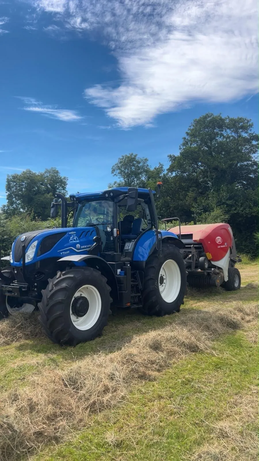 New Holland T7.225 tractor baling hay with a Lely Welger round baler