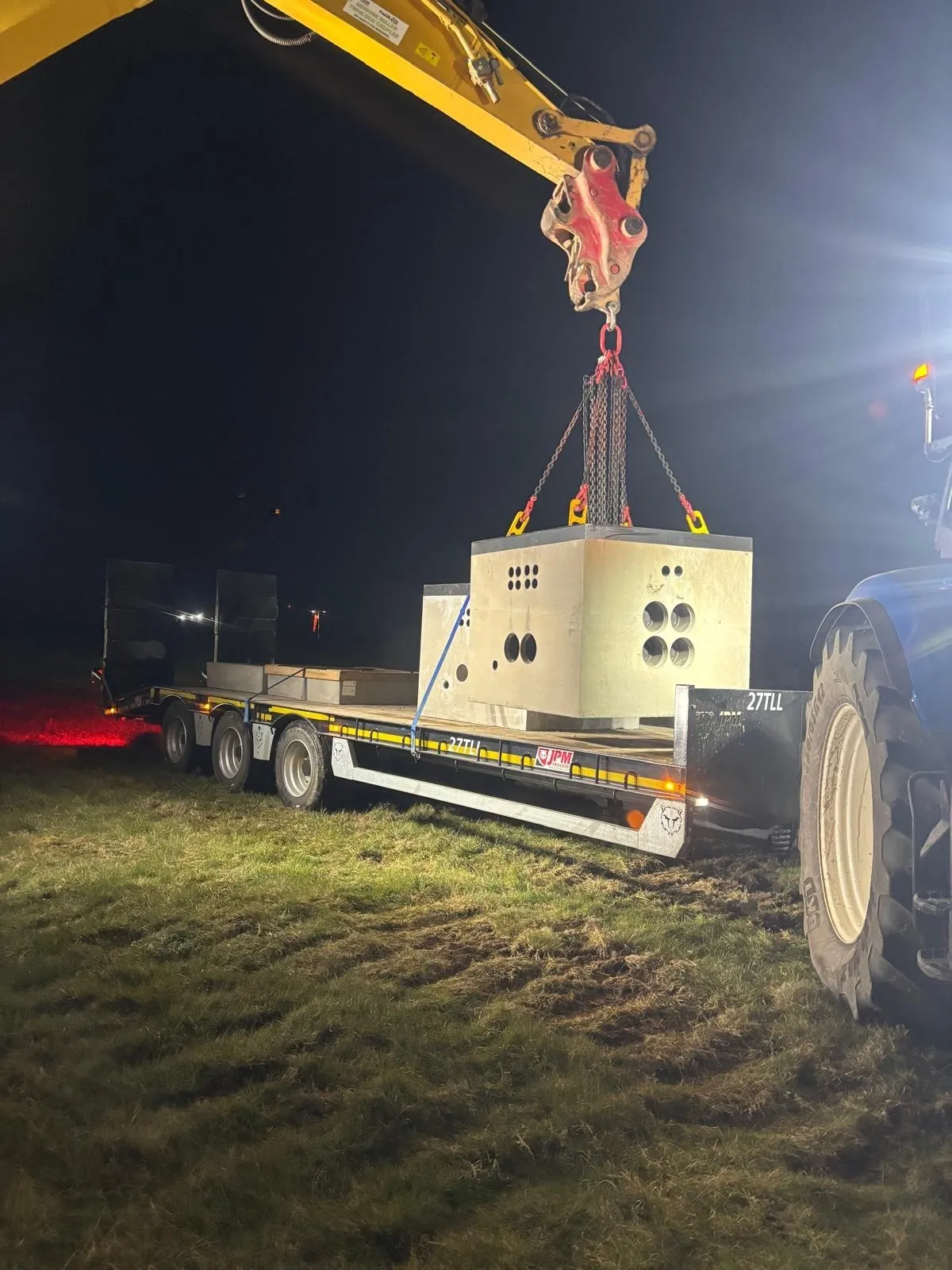 Night-time crane lift of a unit onto a prepared base